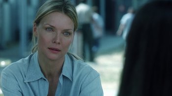 Movie still from “White Oleander” (2002), directed by Peter Kosminsky – A woman sitting in front of a group of people; Close Up shot, Over the shoulder angle