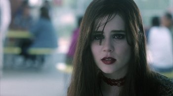 Movie still from “White Oleander” (2002), directed by Peter Kosminsky – A woman with long black hair wearing a red necklace; Close Up shot, Over the shoulder angle