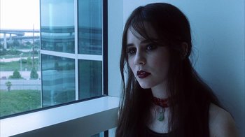 Movie still from “White Oleander” (2002), directed by Peter Kosminsky – A woman with long black hair wearing a necklace; Close Up shot, Low angle