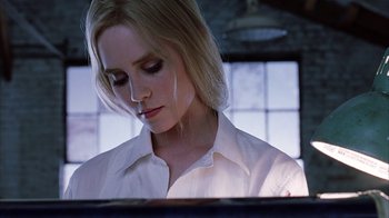 Movie still from “White Oleander” (2002), directed by Peter Kosminsky – A woman in a white shirt is looking down at a computer screen; Close Up shot, Low angle