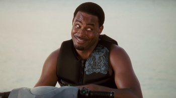 Movie still from “Why Did I Get Married Too?” (2010), directed by Tyler Perry – A person sitting on a chair wearing a life jacket; Close Up shot, Over the shoulder angle