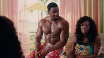 Movie still from “Why Did I Get Married Too?” (2010), directed by Tyler Perry – A man sitting next to a woman on a chair; Medium shot, Over the shoulder angle