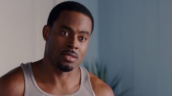 Movie still from “Why Did I Get Married Too?” (2010), directed by Tyler Perry – A person wearing a tank top; Close Up shot, Over the shoulder angle