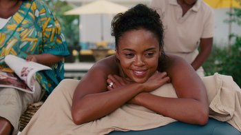 Movie still from “Why Did I Get Married Too?” (2010), directed by Tyler Perry – A beautiful young lady laying on top of a towel; Close Up shot, Over the shoulder angle