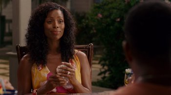 Movie still from “Why Did I Get Married Too?” (2010), directed by Tyler Perry – A woman sitting at a table holding a drink; Close Up shot, Over the shoulder angle