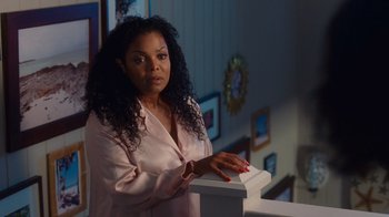 Movie still from “Why Did I Get Married Too?” (2010), directed by Tyler Perry – A woman in a pink robe stands in front of a wall; Medium shot, Over the shoulder angle