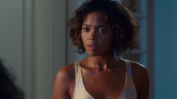 Movie still from “Why Did I Get Married Too?” (2010), directed by Tyler Perry – A beautiful young woman in a white tank top; Close Up shot, Over the shoulder angle