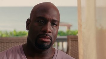 Movie still from “Why Did I Get Married Too?” (2010), directed by Tyler Perry – A man with a bald head is looking at the camera; Close Up shot, Over the shoulder angle