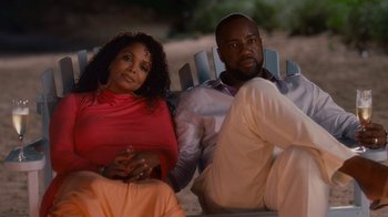 Movie still from “Why Did I Get Married Too?” (2010), directed by Tyler Perry – A man and a woman sitting on a beach chair; Medium shot, High angle