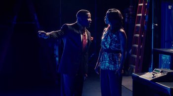 Movie still from “Why Did I Get Married Too?” (2010), directed by Tyler Perry – A man and a woman are standing in a dark room; Medium shot, Over the shoulder angle