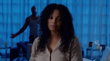 Movie still from “Why Did I Get Married Too?” (2010), directed by Tyler Perry – A woman in a white shirt and a man in a black tank top; Close Up shot, Over the shoulder angle