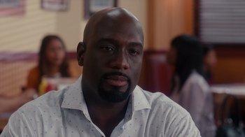 Movie still from “Why Did I Get Married Too?” (2010), directed by Tyler Perry – A person wearing a white shirt; Close Up shot, Over the shoulder angle