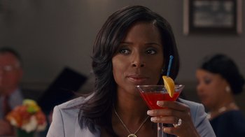 Movie still from “Why Did I Get Married Too?” (2010), directed by Tyler Perry – A woman is holding a drink in her hand; Close Up shot, Over the shoulder angle
