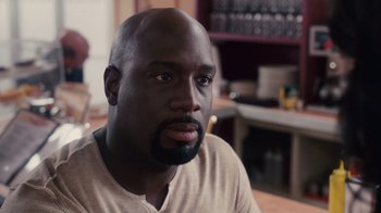 Movie still from “Why Did I Get Married Too?” (2010), directed by Tyler Perry – A person sitting at a table; Close Up shot, High angle
