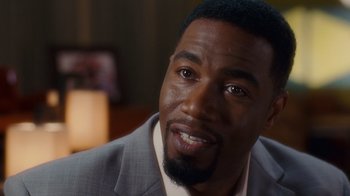 Movie still from “Why Did I Get Married Too?” (2010), directed by Tyler Perry – A person wearing a suit and tie; Close Up shot, Over the shoulder angle