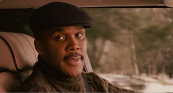 Movie still from “Why Did I Get Married?” (2007), directed by Tyler Perry – A man in a car wearing a hat and a sweater; Close Up shot, Low angle