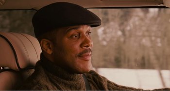 Movie still from “Why Did I Get Married?” (2007), directed by Tyler Perry – A man in a car wearing a hat and a sweater; Close Up shot, Low angle