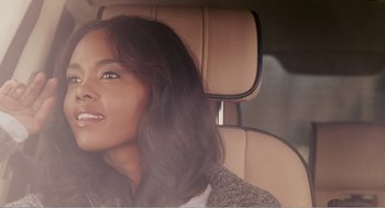 Movie still from “Why Did I Get Married?” (2007), directed by Tyler Perry – A woman sitting in the back seat of a car; Close Up shot, Over the shoulder angle