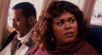 Movie still from “Why Did I Get Married?” (2007), directed by Tyler Perry – A person sitting on a train; Close Up shot, Over the shoulder angle