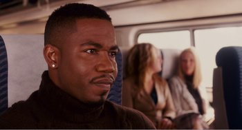 Movie still from “Why Did I Get Married?” (2007), directed by Tyler Perry – A person sitting on a bus; Close Up shot, Over the shoulder angle