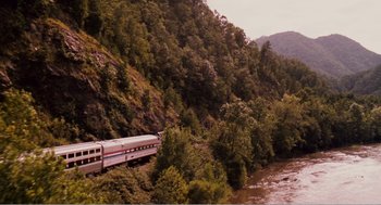 Movie still from “Why Did I Get Married?” (2007), directed by Tyler Perry – A train traveling down tracks next to a river; Extreme Wide shot, High angle