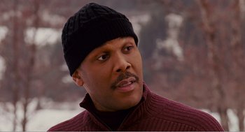 Movie still from “Why Did I Get Married?” (2007), directed by Tyler Perry – A person wearing a sweater and a hat; Close Up shot, High angle