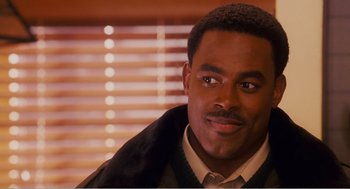 Movie still from “Why Did I Get Married?” (2007), directed by Tyler Perry – A person wearing a suit and tie; Close Up shot, Over the shoulder angle