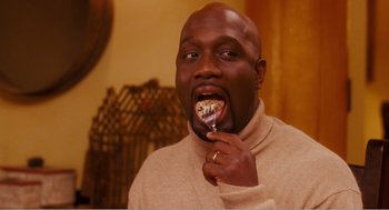Movie still from “Why Did I Get Married?” (2007), directed by Tyler Perry – A man eating a piece of cake with a fork; Close Up shot, High angle