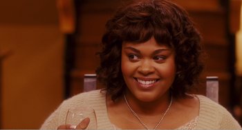 Movie still from “Why Did I Get Married?” (2007), directed by Tyler Perry – A person holding a glass of wine; Close Up shot, Over the shoulder angle