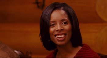 Movie still from “Why Did I Get Married?” (2007), directed by Tyler Perry – A person with a smile on their face; Close Up shot, Over the shoulder angle
