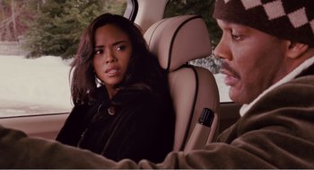 Movie still from “Why Did I Get Married?” (2007), directed by Tyler Perry – A woman sitting in the back of a car next to a man; Close Up shot, Over the shoulder angle