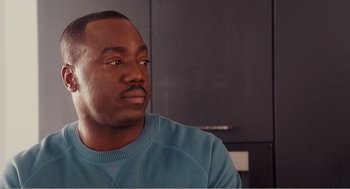 Movie still from “Why Did I Get Married?” (2007), directed by Tyler Perry – A person sitting in a room; Close Up shot, Over the shoulder angle