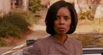 Movie still from “Why Did I Get Married?” (2007), directed by Tyler Perry – A black woman with short black hair wearing a brown jacket; Close Up shot, Over the shoulder angle