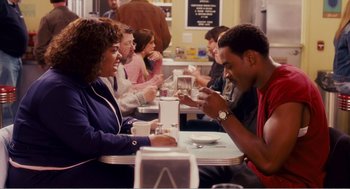 Movie still from “Why Did I Get Married?” (2007), directed by Tyler Perry – A man and a woman sitting at a restaurant table; Medium shot, Over the shoulder angle