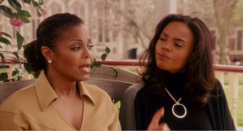 Two women sitting next to each other on a bench