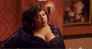 Movie still from “Why Did I Get Married?” (2007), directed by Tyler Perry – A woman in a black dress is looking to her left; Medium shot, Over the shoulder angle
