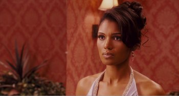 Movie still from “Why Did I Get Married?” (2007), directed by Tyler Perry – A beautiful woman with long dark brown hair wearing a white top; Close Up shot, Over the shoulder angle