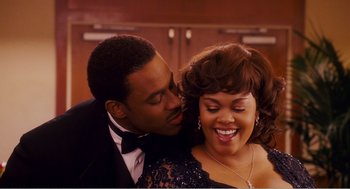 Movie still from “Why Did I Get Married?” (2007), directed by Tyler Perry – A man and a woman in formal wear kissing; Close Up shot, High angle