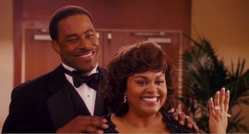 Movie still from “Why Did I Get Married?” (2007), directed by Tyler Perry – A man and a woman posing for a picture; Medium shot, Over the shoulder angle