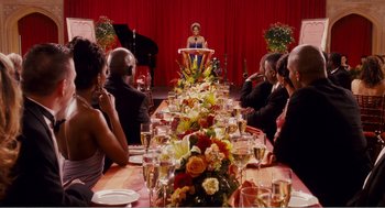 Movie still from “Why Did I Get Married?” (2007), directed by Tyler Perry – A group of people sitting around a long table; Wide shot, Over the shoulder angle