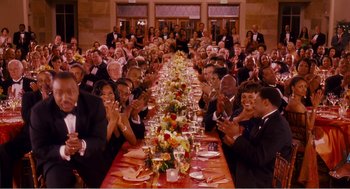 Movie still from “Why Did I Get Married?” (2007), directed by Tyler Perry – A group of people sitting around a long table; Extreme Wide shot, High angle