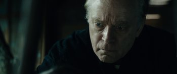 Movie still from “Wildling” (2018), directed by Fritz Böhm – An older man with blue eyes stares at the camera; Close Up shot, Over the shoulder angle