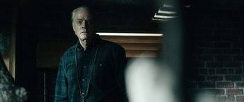 Movie still from “Wildling” (2018), directed by Fritz Böhm – An older man standing in front of a mirror; Close Up shot, Over the shoulder angle