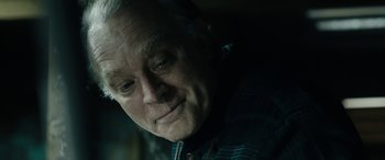 Movie still from “Wildling” (2018), directed by Fritz Böhm – An older man looking at something in the distance; Close Up shot, Over the shoulder angle