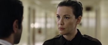 Movie still from “Wildling” (2018), directed by Fritz Böhm – A person wearing a uniform; Close Up shot, Over the shoulder angle