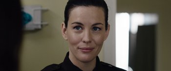 Movie still from “Wildling” (2018), directed by Fritz Böhm – A person wearing a police uniform; Close Up shot, Over the shoulder angle