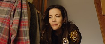 Movie still from “Wildling” (2018), directed by Fritz Böhm – A woman in a police uniform sitting in front of a wall; Close Up shot, Over the shoulder angle