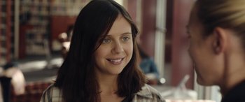 Movie still from “Wildling” (2018), directed by Fritz Böhm – A person with long brown hair; Close Up shot, Over the shoulder angle