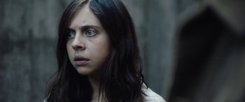 Movie still from “Wildling” (2018), directed by Fritz Böhm – A woman with long black hair and blue eyes looking to her left; Close Up shot, Over the shoulder angle