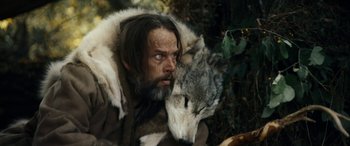 Movie still from “Wildling” (2018), directed by Fritz Böhm – A man with a beard and a wolf's face; Close Up shot, Over the shoulder angle